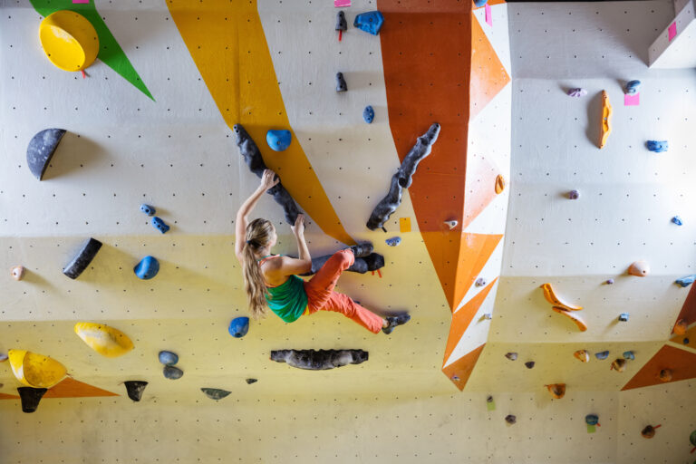 young-woman-bouldering-in-climbing